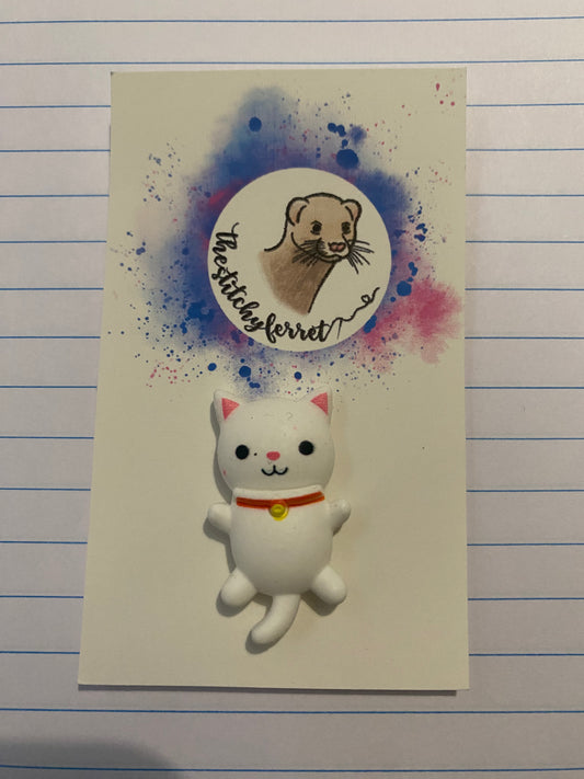 White cat needle minder